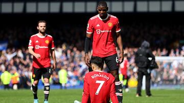 LIVERPOOL, ENGLAND - APRIL 09: Cristiano Ronaldo goes down with an injury in front of Paul Pogba of Manchester United during the Premier League match between Everton and Manchester United at Goodison Park on April 09, 2022 in Liverpool, England. (Photo by