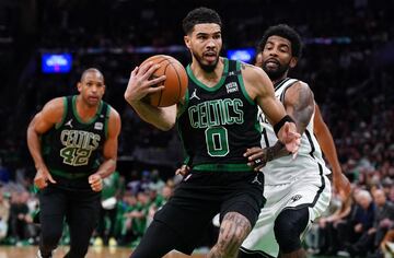 Boston Celtics forward Jayson Tatum (0) drives the ball against Brooklyn Nets guard Kyrie Irving (11)