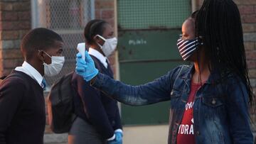 A teacher screens students as schools begin to reopen after the coronavirus disease (COVID-19) lockdown in Langa township in Cape Town, South Africa June 8, 2020. REUTERS/Mike Hutchings