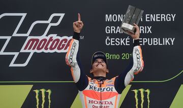 Winner Repsol Honda Team's Spanish rider Marc Marquez celebrates on the podium after the MotoGP event of the Grand Prix of the Czech Republic in Brno on August 6, 2017. / AFP PHOTO / Michal Cizek