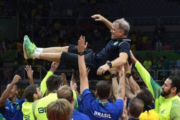 Gold medallists Brazil toss up coach Bernardo Rezende after winning the men's Gold Medal.