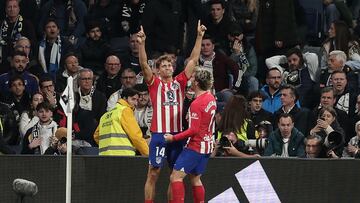 Atletico Madrid's Spanish midfielder #14 Marcos Llorente celebrates with Atletico Madrid's French forward #07 Antoine Griezmann after scoring his team's first goal during the Spanish league football match between Real Madrid CF and Club Atletico de Madrid at the Santiago Bernabeu stadium in Madrid on February 4, 2024. (Photo by Thomas COEX / AFP)