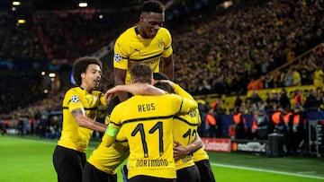 Dortmund's Portuguese defender Raphael Guerreiro (hidden) celebrates scoring the 2-0 goal with his team-mates during the UEFA Champions League group A football match BVB Borussia Dortmund v Atletico de Madrid in Dortmund, western Germany on October 2