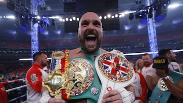 Tyson Fury celebrates with the belts after winning his fight against Dillian Whyte.