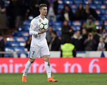 Real Madrid's Portuguese forward Cristiano Ronaldo takes the ball at the end of the Spanish League football match between Real Madrid CF and Girona FC at the Santiago Bernabeu stadium in Madrid on March 18, 2018.