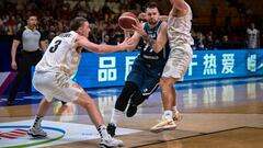Slovenia�s Luka Doncic (C) fights for the ball with New Zealand�s Finn Delany (L) during the 2024 FIBA Olympic Qualifying Tournament basketball match between New Zealand and Slovenia at the Peace and Friendship Stadium in Athens on July 4, 2024. (Photo by Aris MESSINIS / AFP)