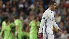 Real Madrid&#039;s Cristiano Ronaldo walks away as Sporting players, rear, celebrate scoring their side&#039;s first goal during a Champions League, Group F soccer match between Real Madrid and Sporting, at the Santiago Bernabeu stadium in Madrid, Spain, Wednesday, Sept. 14, 2016. (AP Photo/Daniel Ochoa de Olza)