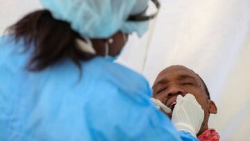 FILE PHOTO: A medical worker wearing personal protective equipment (PPE) takes a swab sample from a man, as South Africa starts to relax some aspects of a stringent nationwide coronavirus disease (COVID-19) lockdown in Diepsloot near Johannesburg, South A