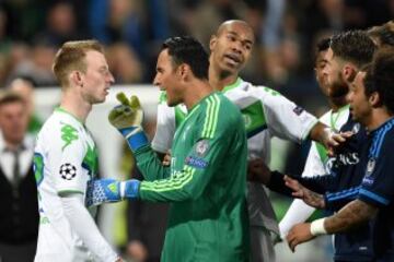 Maximilian Arnold (1st L) of Wolfsburg and Keylor Navas (2nd L) of Real Madrid square off during the UEFA Champions League Quarter Final First Leg