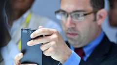 A man tests out an iPhone 7 Plus during a media event at Bill Graham Civic Auditorium in San Francisco, California on September 7, 2016.   / AFP PHOTO / Josh Edelson