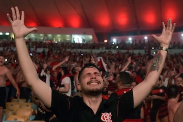 Fans of Brazil's Flamengo react after their team defeated Argentina's River Plate in the Copa Libertadores football final, during the match broadcasting at a Fan Fest event in Maracana stadium, Rio de Janeiro on November 23, 2019.