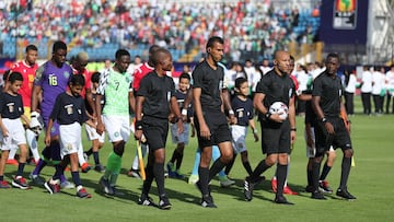 Soccer Football - Africa Cup of Nations 2019 - Group B - Nigeria v Guinea - Alexandria Stadium, Alexandria, Egypt - June 26, 2019  The referee and match officials lead out the teams before the match  REUTERS/Suhaib Salem