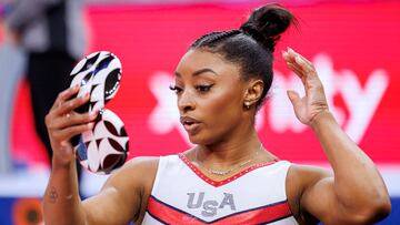 US gymnast Simone Biles looks at herself in a mirror during the Women's Day Four of 2024 US Olympic Gymnastics Trials at the Target Center in Minneapolis, Minnesota, on June 30, 2024. (Photo by Kerem YUCEL / AFP)