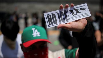 A demonstrator holds a sticker against the Immigration and Customs Enforcement (ICE), during a protest against federal immigration sweeps in downtown Los Angeles, California, U.S. June 8, 2025. REUTERS/Daniel Cole