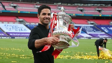 Arsenal&#039;s Spanish head coach Mikel Arteta holds the winner&#039;s trophy as the team celebrates victory after the English FA Cup final football match between Arsenal and Chelsea at Wembley Stadium in London, on August 1, 2020. - Arsenal won the match