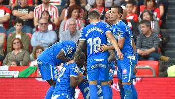 Getafe's Uruguayan defender Damian Suarez (BOTTOM) celebrates his goal with teammates during the Spanish league football match between Athletic Club Bilbao and Getafe CF at the San Mames stadium in Bilbao on February 2, 2020. (Photo by ANDER GILLENEA