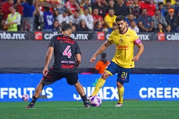   Nicolas Diaz (R) of Tijuana dights for the ball with Henry Martin (R) of America during the 13th round match between Tijuana and America as part of the Liga BBVA MX, Torneo Apertura 2024 at Caliente Stadium on October 23, 2024 in Tijuana, Baja California, Mexico.