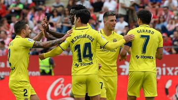 Villarreal's Spanish forward Gerard Moreno (R) celebrates scoring his team's second goal during the Spanish league football match between Girona FC and Villarreal CF at the Montilivi stadium in Girona on May 20, 2023. (Photo by Josep LAGO / AFP)