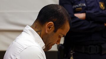 (FILES) Brazilian footballer Dani Alves looks down during his trial at the High Court of Justice of Catalonia in Barcelona, on February 5, 2024. Ex-Brazil star Dani Alves has been sentenced to 4.5 years in jail for rape, Barcelona's court announced on February 22, 2024. (Photo by ALBERTO EST�VEZ / POOL / AFP)