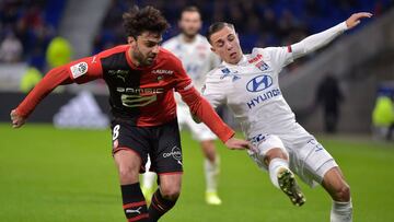 Lyon&#039;s French midfielder Maxence Caqueret (R) fights for the ball with Rennesx92 French midfielder Clement Grenier (L) during the French L1 football match between Olympique Lyonnais and Stade Rennais Football Club at the Groupama stadium in Decines-C