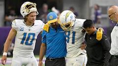 Justin Herbert #10 of the Los Angeles Chargers, watches as Los Angeles Chargers staff help Mike Williams #81 of the Los Angeles Chargers off the field