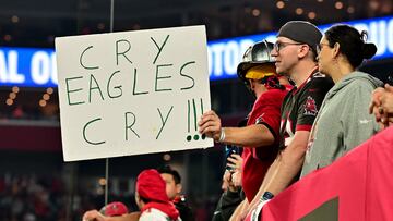 TAMPA, FLORIDA - JANUARY 15: A Tampa Bay Buccaneers fan holds a sign that reads, "Cry Eagles Cry!!!" during the fourth quarter in the NFC Wild Card Playoffs between the Philadelphia Eagles and the Tampa Bay Buccaneers at Raymond James Stadium on January 15, 2024 in Tampa, Florida.   Julio Aguilar/Getty Images/AFP (Photo by Julio Aguilar / GETTY IMAGES NORTH AMERICA / Getty Images via AFP)