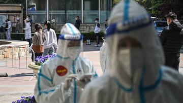 Residents wait in a line to be tested for the Covid-19 coronavirus during the second stage of a pandemic lockdown in Jing' an district in Shanghai on April 4, 2022.