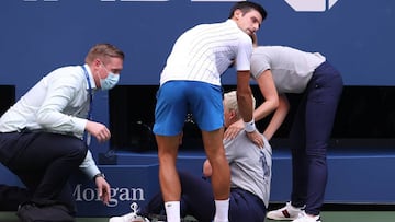 NEW YORK, NEW YORK - SEPTEMBER 06: Novak Djokovic of Serbia tends to a line judge who was hit with the ball during his Men&#039;s Singles fourth round match against Pablo Carreno Busta of Spain on Day Seven of the 2020 US Open at the USTA Billie Jean King National Tennis Center on September 6, 2020 in the Queens borough of New York City.   Al Bello/Getty Images/AFP
 == FOR NEWSPAPERS, INTERNET, TELCOS &amp; TELEVISION USE ONLY ==