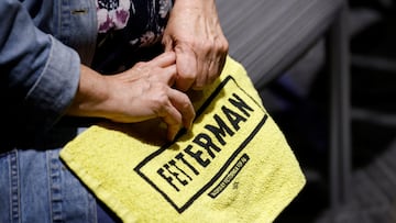 A woman holds a campaign towel at a campaign rally for Pennsylvania Democratic U.S. Senate candidate John Fetterman ahead of the 2022 U.S. midterm election in Pittsburgh, Pennsylvania, U.S. November 7, 2022.  REUTERS/Quinn Glabicki