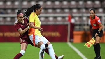 (FILES) Venezuela's Maria Peraza (L) and Colombia's Mayra Ramirez fight for the ball during the women's friendly football match between Venezuela and Colombia at the Metropolitano stadium in Barquisimeto, Venezuela, on May 30, 2024. The tenth edition of the Women's Copa America, which has been held since 1991, will be played in Quito (at 2,850 meters above sea level) starting on June 11, 2025, and will award three tickets to the 2027 Pan American Games in Lima and two to the 2028 Olympic Games in Los Angeles. (Photo by Federico PARRA / AFP)