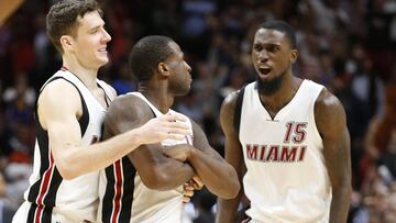 Miami Heat guard Goran Dragic, left, and forward Okaro White (15) congratulate guard Dion Waiters, center, after Waiters scored a 3-pointer with 0.6 seconds left in an NBA basketball game against the Golden State Warriors, Monday, Jan. 23, 2017, in Miami. Waiters had 33 points as the Heat defeated the Warriors 105-102. (AP Photo/Wilfredo Lee)