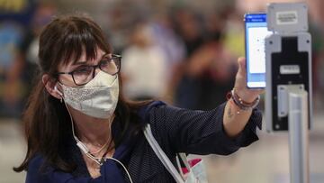 A woman wearing a face mask scans a QR-code to check her turn to take a train at Constitucion train station, amid a rise in cases of the coronavirus disease (COVID-19), in Buenos Aires, Argentina April 8, 2021. REUTERS/Agustin Marcarian