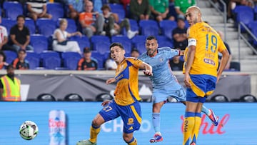 Aug 13, 2024; Harrison, New Jersey, USA; New York City FC midfielder Maxi Moralez (27) scores a goal as Tigres UANL defender Jesus Angulo (27) and midfielder Guido Pizarro (19) defend during the first half at Red Bull Arena. Mandatory Credit: Vincent Carchietta-USA TODAY Sports