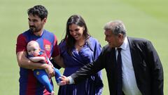 (From L) FC Barcelona's newly-signed German midfielder Ilkay Gundogan poses for pictures with his newborn son, his wife Sara Arfaoui and FC Barcelona's President Joan Laporta during his official presentation at the Joan Gamper training ground in Sant Joan Despi on July 17, 2023. (Photo by LLUIS GENE / AFP)
