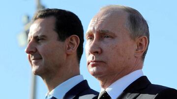 FILE PHOTO: Russian President Vladimir Putin (R) and Syrian President Bashar al-Assad visit the Hmeymim air base in Latakia Province, Syria December 11, 2017. Picture taken December 11, 2017. To match Special Report RUSSIA-FLIGHTS/ Sputnik/Mikhail Klimentyev/ via REUTERS/File Photo ATTENTION EDITORS - THIS IMAGE WAS PROVIDED BY A THIRD PARTY./File Photo