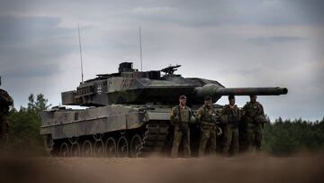 07 June 2022, Lithuania, Pabrade: Soldiers stand in front of a German Army Leopard-2 tank used by the NATO Enhanced Forward Presence Battle Group (eFP battalion) during Chancellor Scholz's visit to Camp Adrian Rohn. Scholz pledged additional military support to Lithuania to defend against a possible Russian attack. Photo: Michael Kappeler/dpa (Photo by Michael Kappeler/picture alliance via Getty Images)