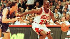 (FILES) In this file photo taken on June 4, 1997 former Chicago Bulls player Michael Jordan sticks out his tongue as he goes past Jeff Hornacek of the Utah Jazz during game two of the NBA Finals at the United Center in Chicago, IL. - Michael Jordan believ