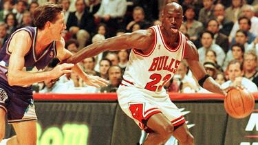 (FILES) In this file photo taken on June 4, 1997 former Chicago Bulls player Michael Jordan sticks out his tongue as he goes past Jeff Hornacek of the Utah Jazz during game two of the NBA Finals at the United Center in Chicago, IL. - Michael Jordan believ