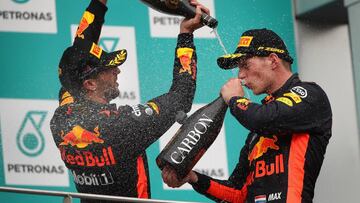 KUALA LUMPUR, MALAYSIA - OCTOBER 01:  Race winner Max Verstappen of Netherlands and Red Bull Racing celebrates with third place finisher Daniel Ricciardo of Australia and Red Bull Racing on the podium during the Malaysia Formula One Grand Prix at Sepang Circuit on October 1, 2017 in Kuala Lumpur, Malaysia.  (Photo by Clive Mason/Getty Images)