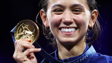 Gold medallist US' Lee Kiefer celebrates on the podium during the medal ceremony for the women's foil individual competition during the Paris 2024 Olympic Games at the Grand Palais in Paris, on July 28, 2024. (Photo by Franck FIFE / AFP)