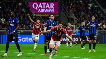AC Milan's Serbian forward #09 Luka Jovic (C) celebrates after scoring AC Milan's first goal during the Coppa Italia second leg semi-final football match between Inter Milan and AC Milan at the San Siro stadium in Milan on April 23, 2025. (Photo by Piero CRUCIATTI / AFP)