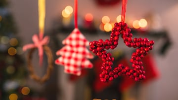 Close-up of christmas ornaments hanging on ribbon at home