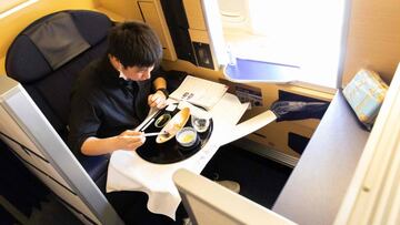 In this handout photograph taken on March 31, 2021 by All Nippon Airways (ANA), a customer has his meal on a parked plane at Haneda airport in Tokyo. - Airline food might be one of the last things people are missing during the pandemic, but Japanese carri