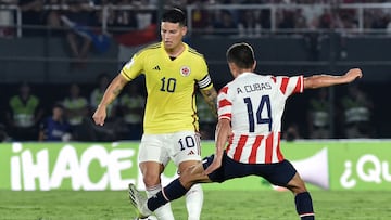 Colombia's midfielder James Rodriguez (L) and Paraguay's midfielder Andres Cubas fight for the ball during the 2026 FIFA World Cup South American qualification football match between Paraguay and Colombia at the Defensores del Chaco stadium in Asuncion on November 21, 2023. (Photo by NORBERTO DUARTE / AFP)