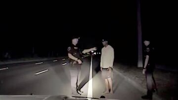 Tiger Woods is seen performing field sobriety tests following orders from a police officer (L) in this still image from police dashcam video in Jupiter, Florida, U.S. on May 29, 2017.