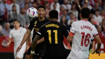 Real Madrid's English midfielder #5 Jude Bellingham looks at the ball during the Spanish league football match between Sevilla FC and Real Madrid CF at the Ramon Sanchez Pizjuan stadium in Seville on October 21, 2023. (Photo by CRISTINA QUICLER / AFP)
