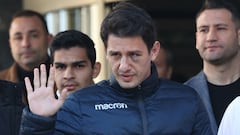 Turkish football referee Umut Meler waves as he leaves the hospital where he was treated in Ankara, on December 13, 2023, one day after he was attacked on the pitch by a club president. The top-flight Super Lig indefinitely suspended matches and a court placed MKA Ankaragucu club president Faruk Koca and two others in pre-trial detention for "injuring and threatening a public official". (Photo by Adem ALTAN / AFP)