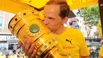 Dortmund head coach Thomas Tuchel kisses the DFB Cup trophy during an open top bus parade at Borsigplatz in Dortmund, Germany, 28 May 2017.