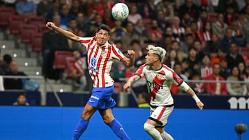 Atletico Madrid's Argentine defender #16 Nahuel Molina Lucero (L) goes for a header challenged by Rayo Vallecano's Spanish defender #03 Pep Chavarria during the Spanish league football match between Club Atletico de Madrid and Rayo Vallecano de Madrid at the Metropolitano stadium in Madrid on September 24, 2025. (Photo by Javier SORIANO / AFP)