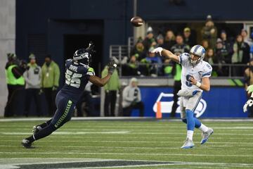 Matthew Stafford lanza un pase presionado por Cliff Avril.